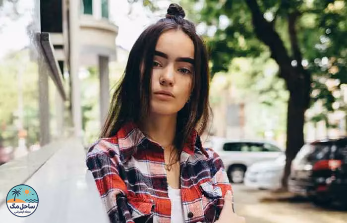 Woman with half top-knot and face-framing strands