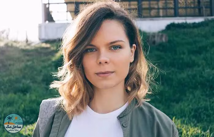 Woman with tousled wavy lob and side-swept bangs